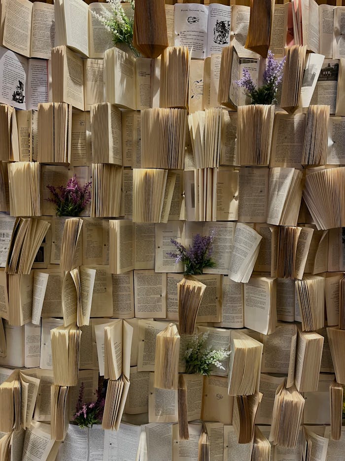A creative display of open vintage books with lavender and flowers, perfect for a rustic aesthetic.